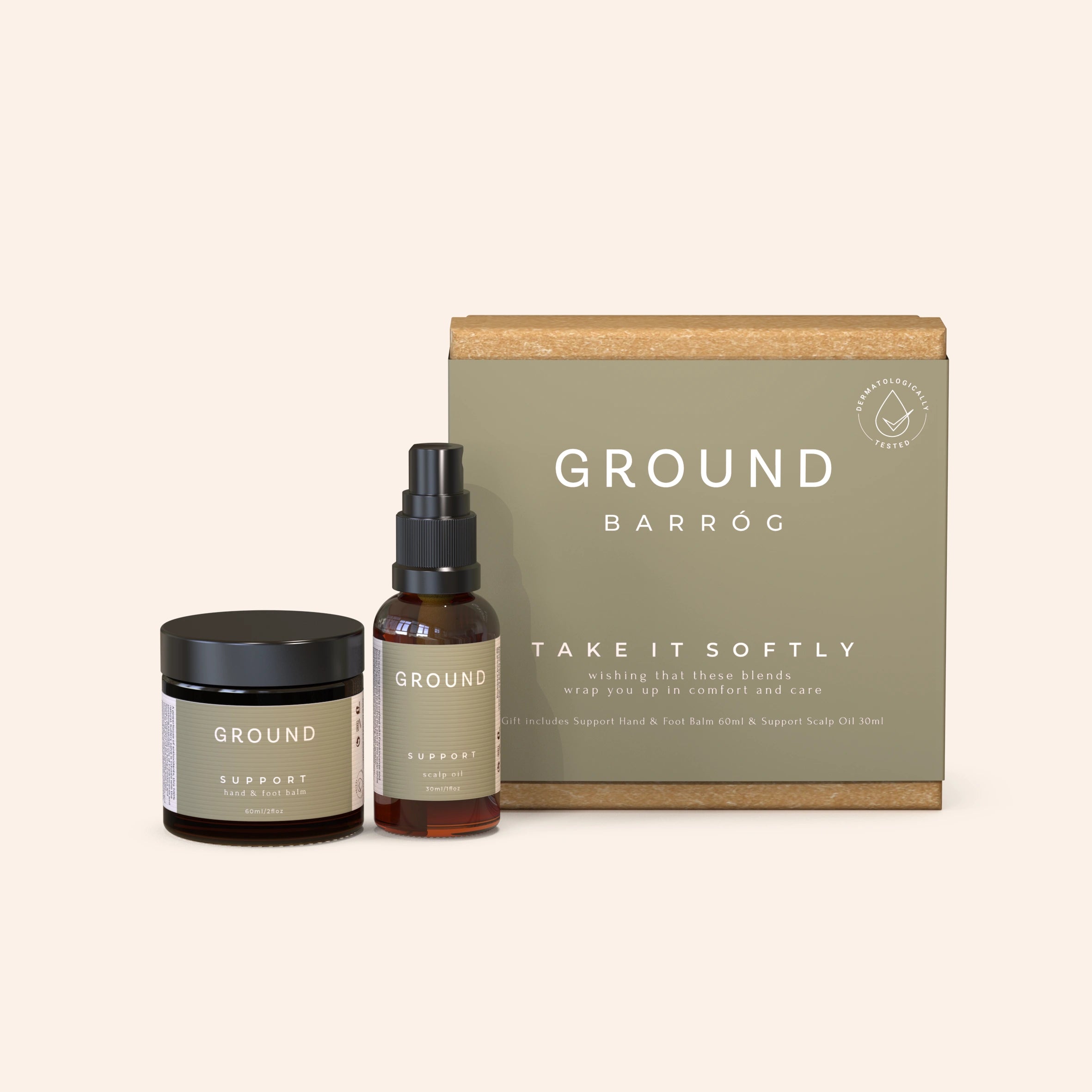 A medium-sized gift box labelled 'Take It Softly' from Ground Barrog collection, next to a jar and a spray bottle of related products, all designed for cancer care.