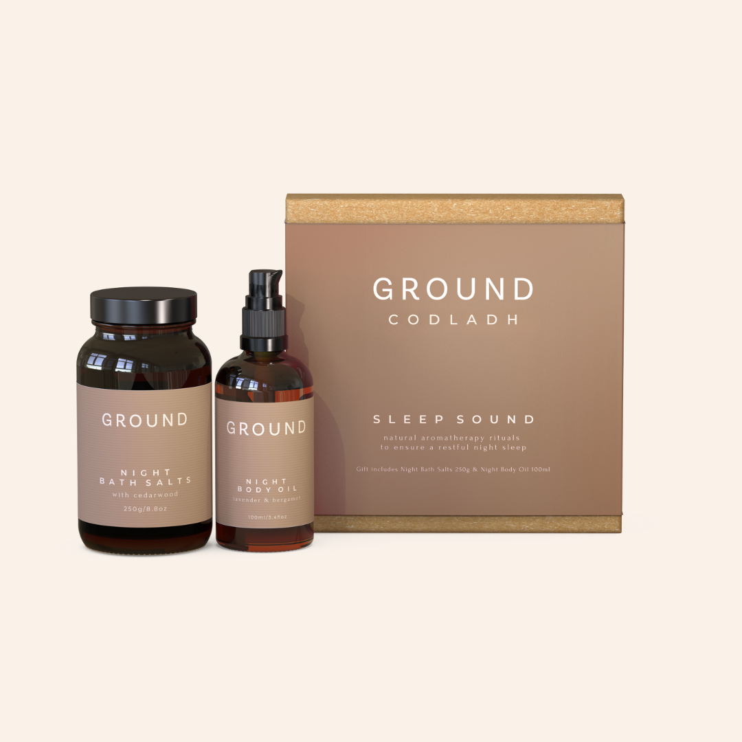 A gift set from Ground Codlach including a bottle of Night Body Oil and a jar of Night Bath Salts, packaged in a brown cardboard box with 'SLEEP SOUND' printed on it.