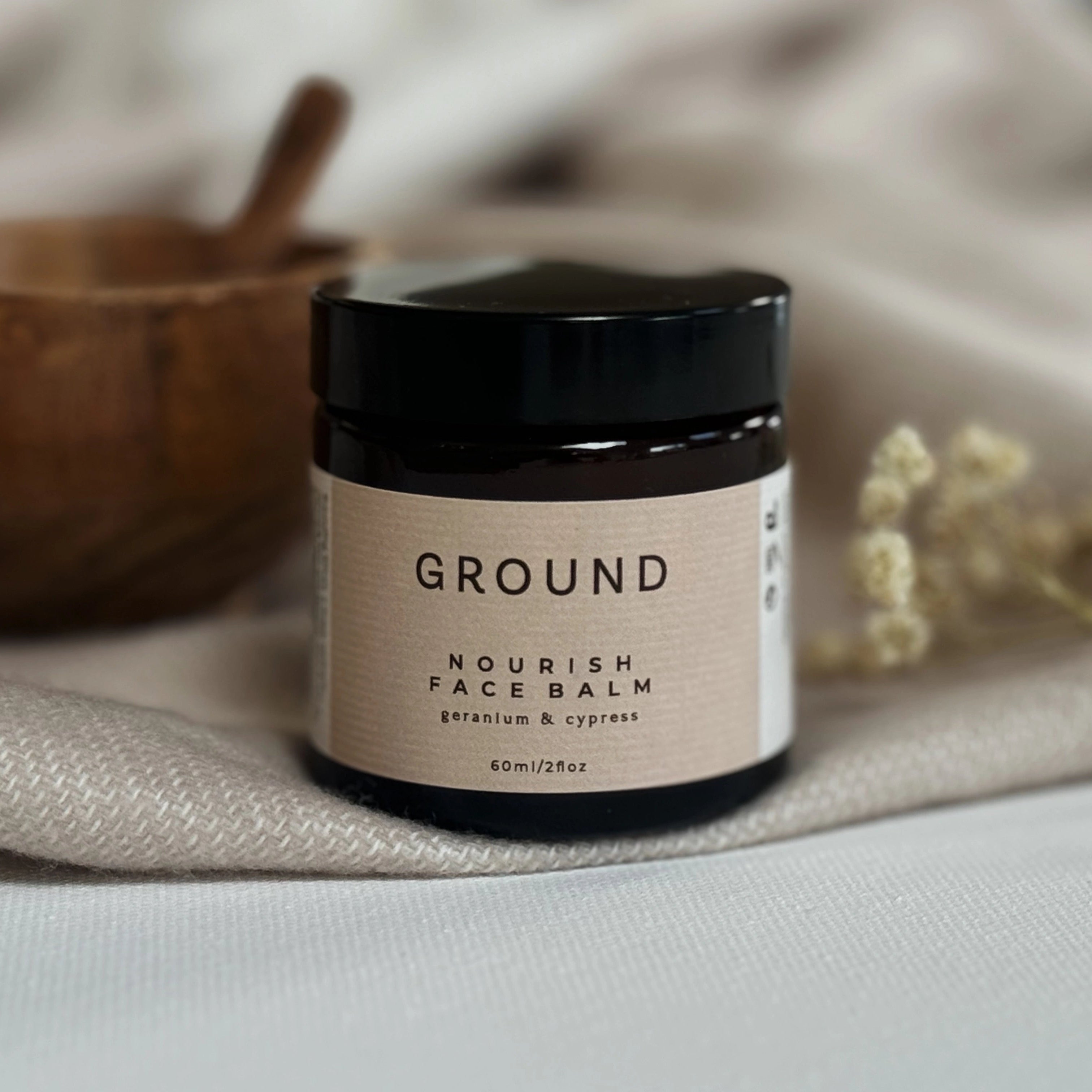 Photograph of a glass jar of Ground Nourish Face Balm containing geranium and cypress.