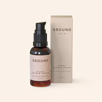 Ground Biome Repair Serum in a brown glass bottle with a beige label and beige packaging on a white background.