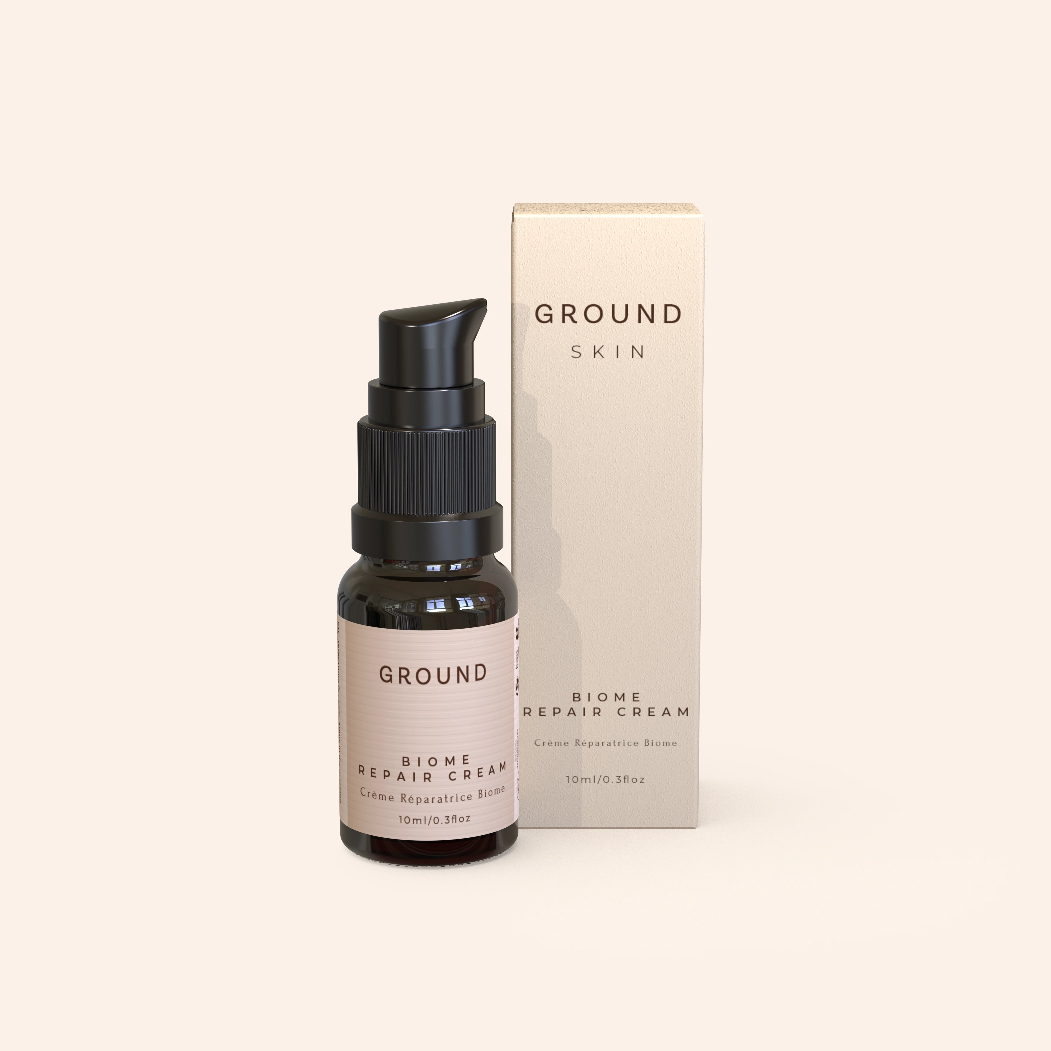 Photo of a 10ml bottle of Ground Skin Biome Repair Cream. It is a light cream cardboard package beside a small bottle of cream.