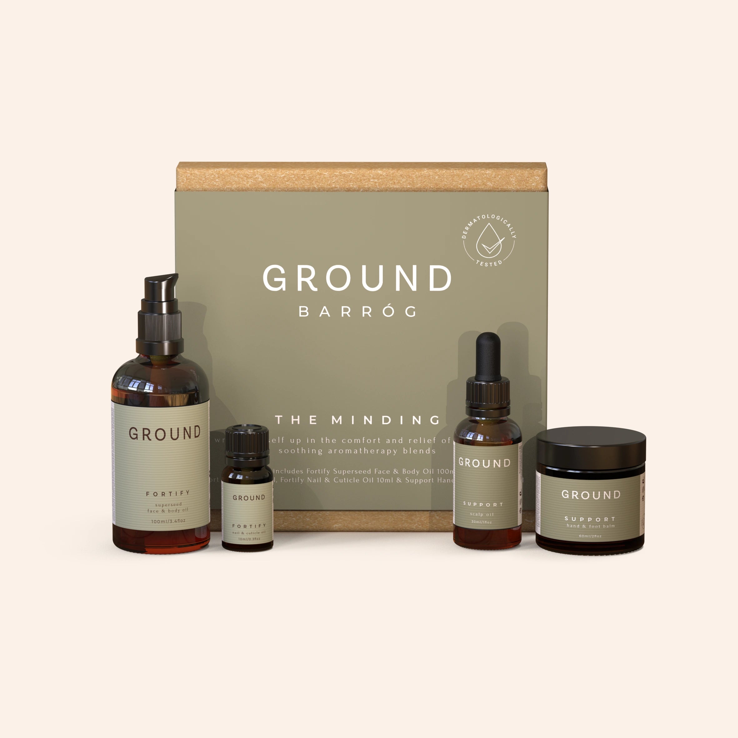 An extra large gift box labelled 'GROUND - The Minding'. 
Displayed in front of the box are bottles of face and body oil, hand and foot balm, nail and cuticle oil, and scalp relief oil.