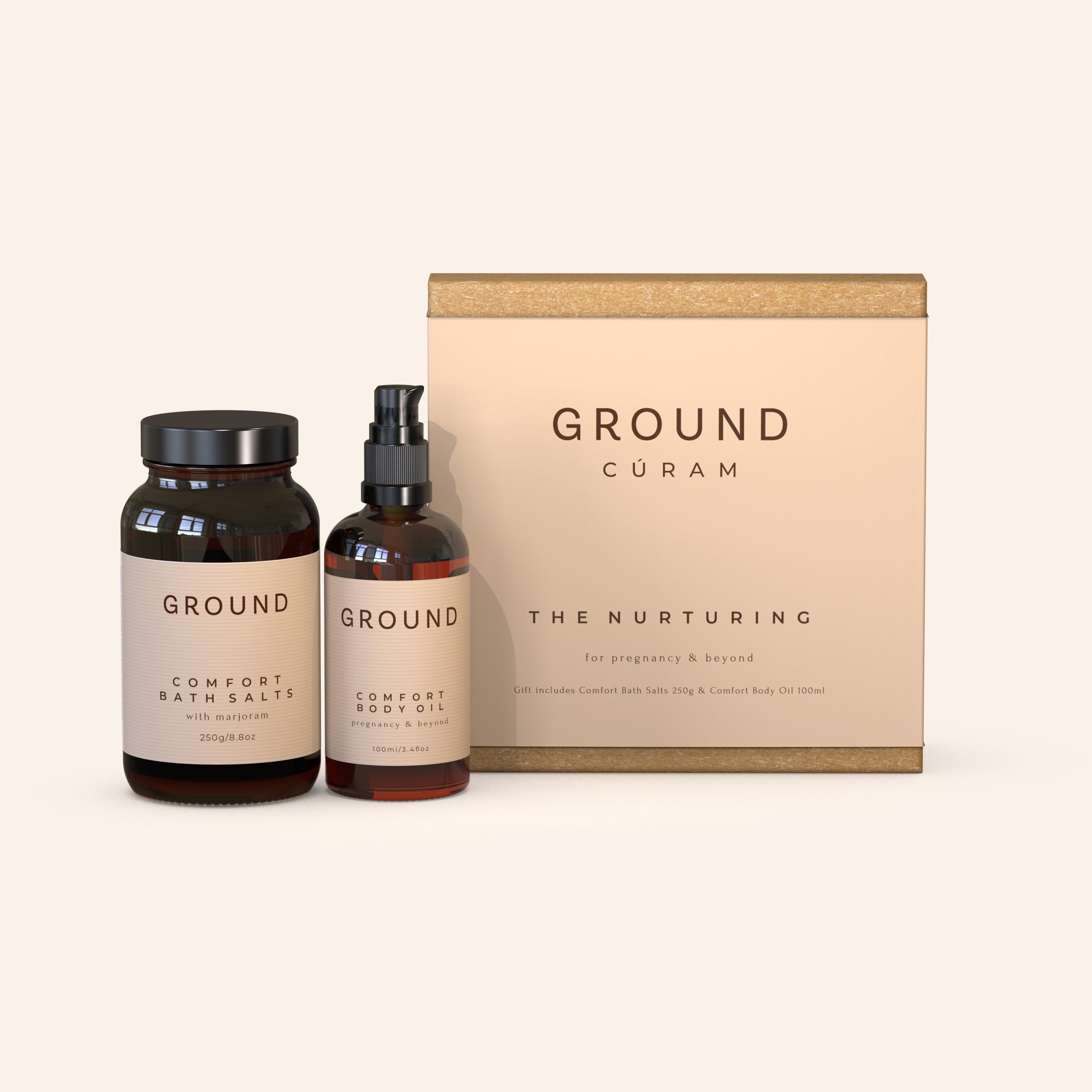 A large gift box with the text 'GROUND CURAM THE NURTURING' in front of two bottles, one labelled 'Comfort Bath Salts' with marjoram and the other 'Comfort Body Oil' for pregnancy and beyond.