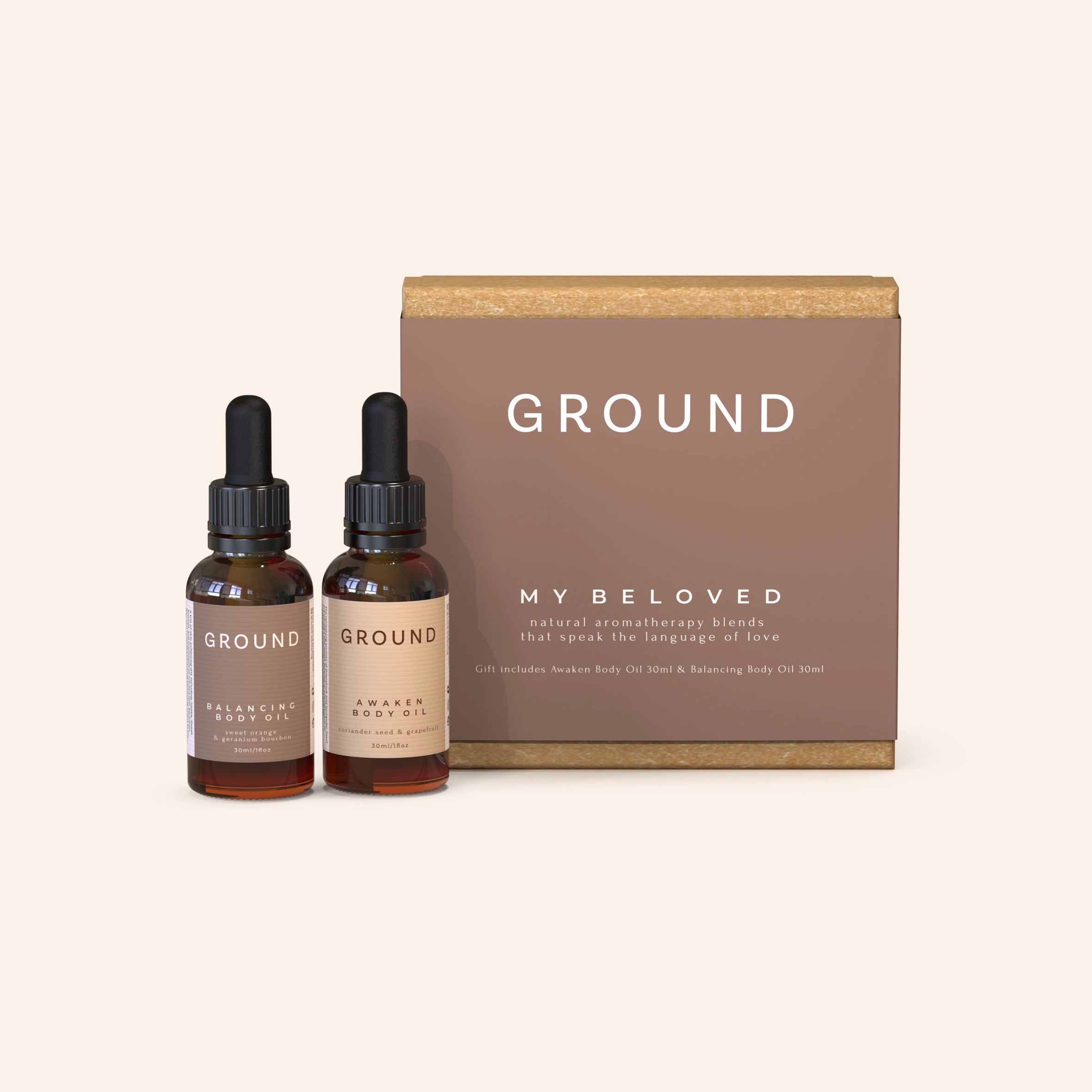 Two bottles of body oil next to their packaging box, labelled 'GROUND' and 'MY BELOVED'. One oil is called Balancing Body Oil, and the second is named Awaken Body Oil. Natural aromatherapy blends that speak the language of love.
