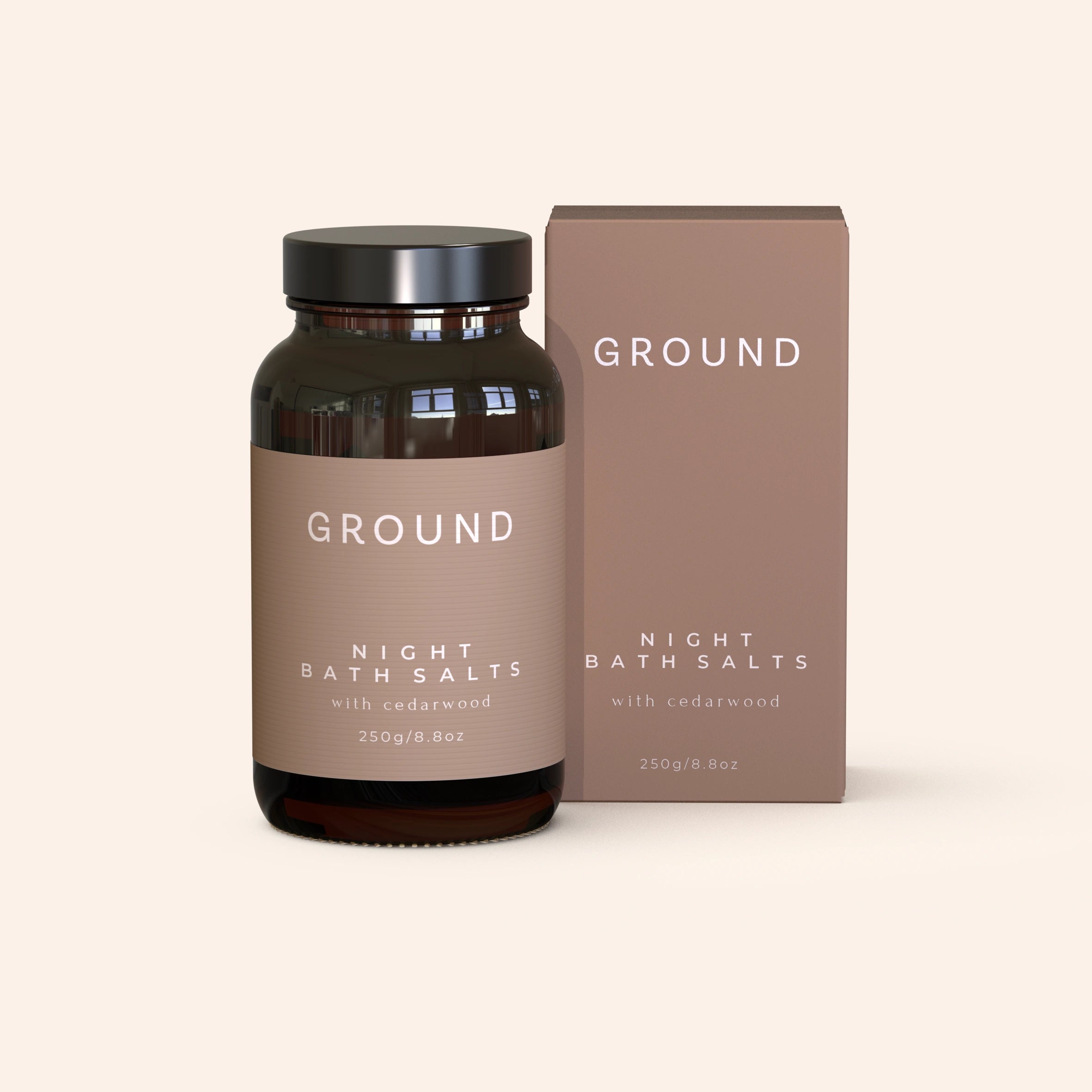 A jar and box of GROUND Wellbeing Night Bath Salts with packaging that indicates the product is a sleeping aid bath salt, 250g size, in a neutral brown color scheme. The salts contain cedarwood.