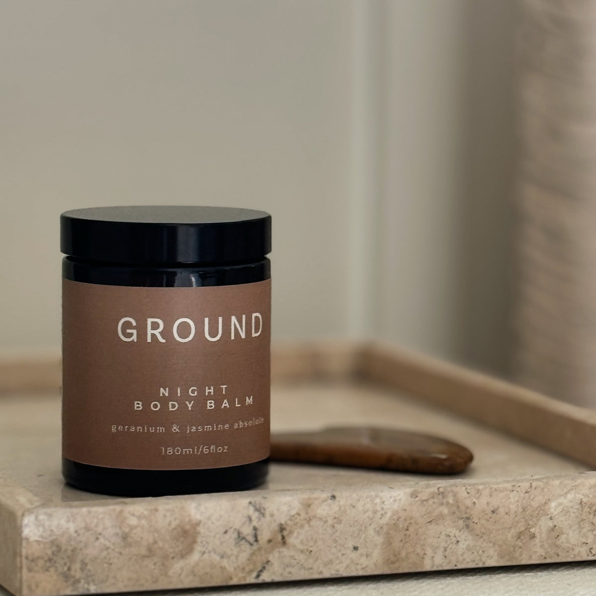 Night body Balm 180ml on stonetop counter with gua sha