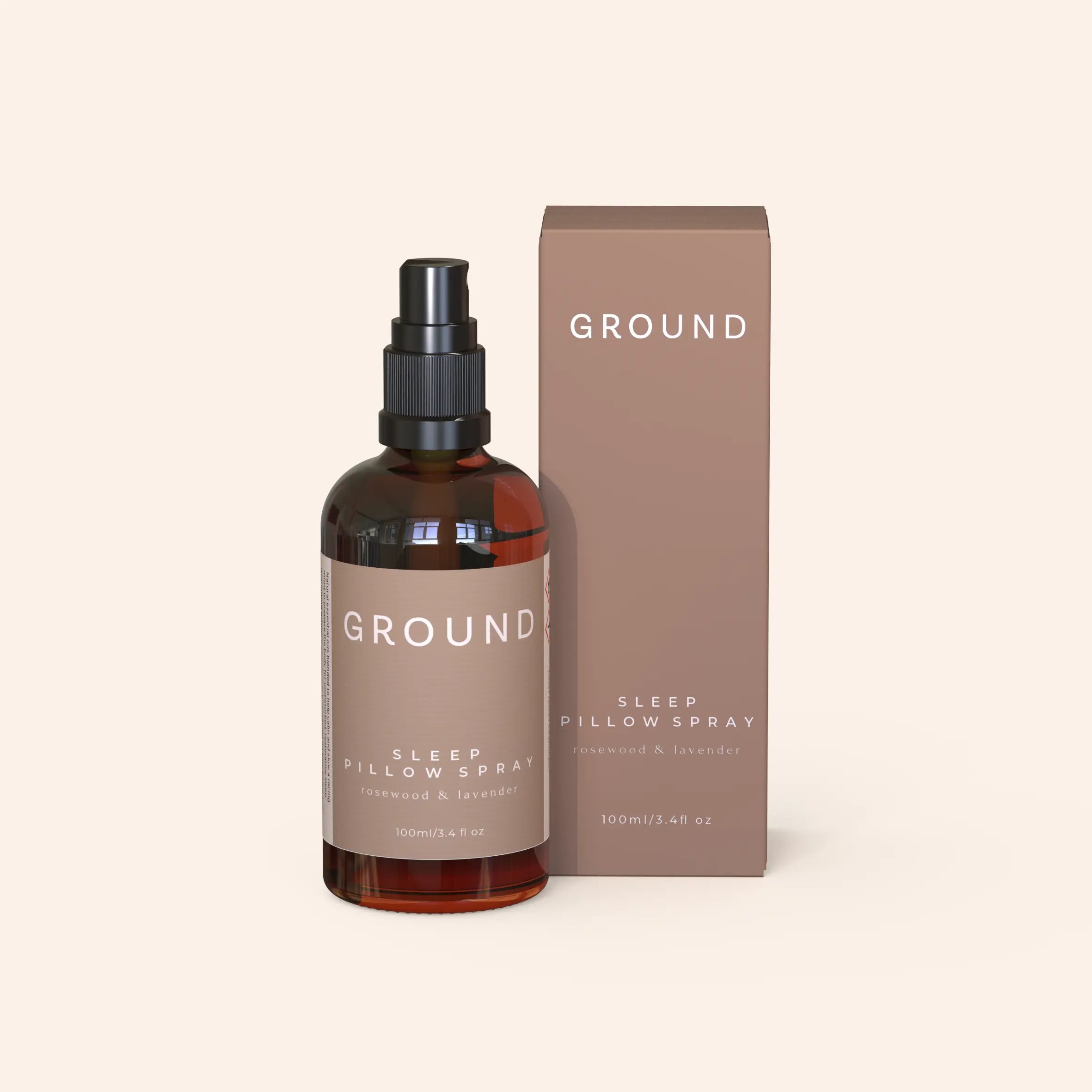Bottle of Ground Sleep Pillow Spray in front of its cardboard packaging. This spray contains rosewood and lavender.