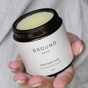 hand holding an open cleansing balm